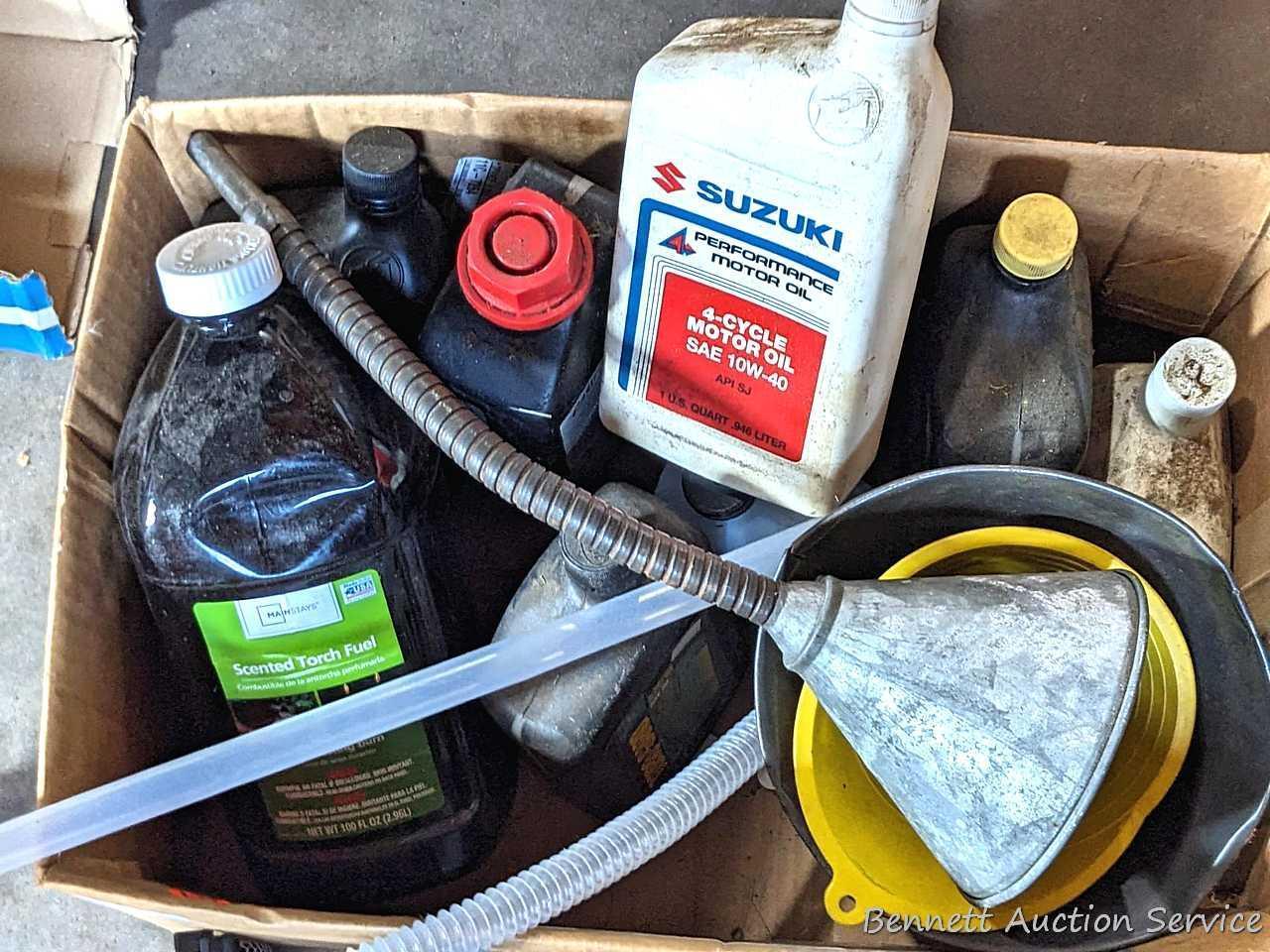 Several bottles of ATV oil, yard torch and fuel, and more.
