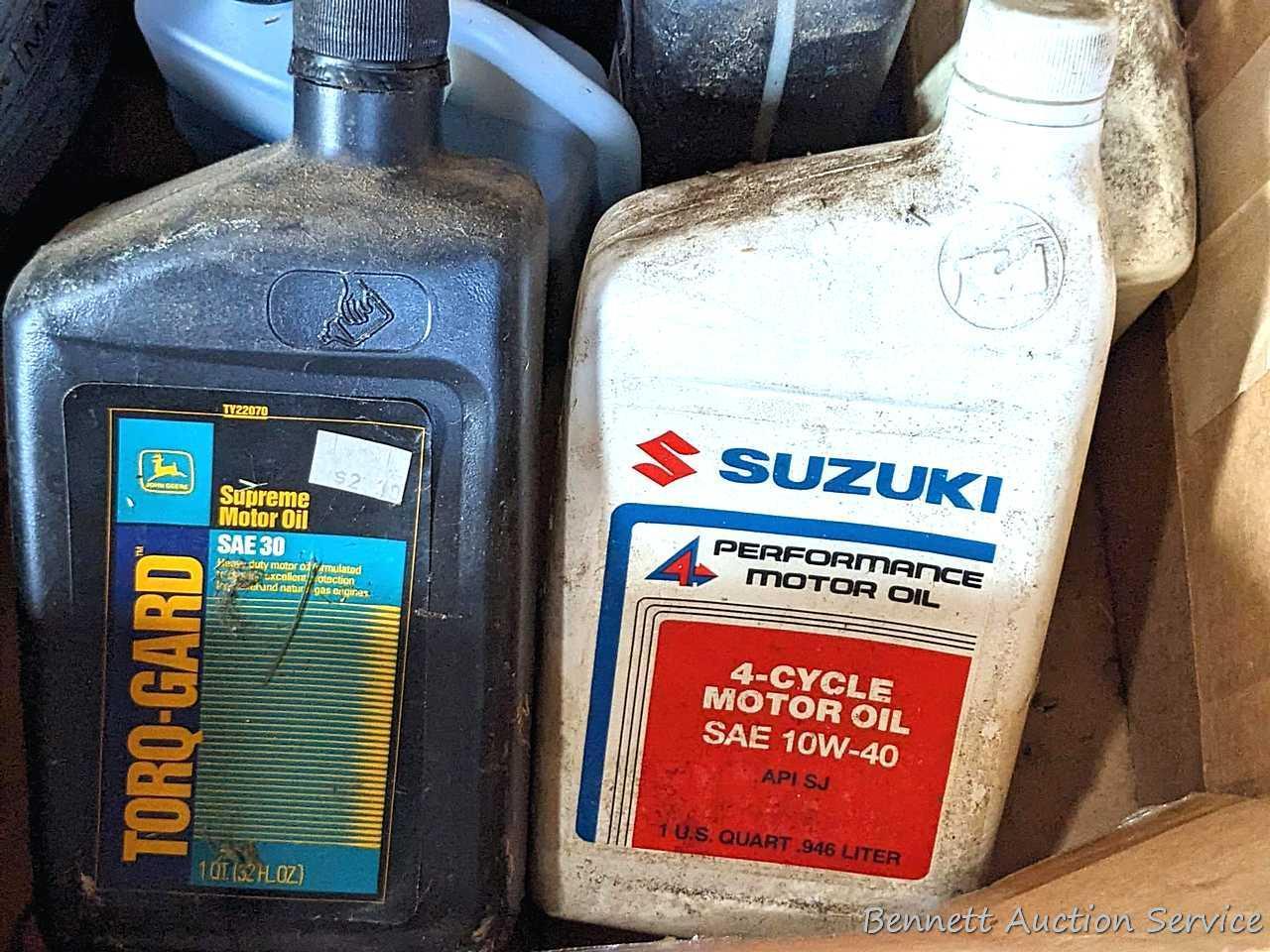 Several bottles of ATV oil, yard torch and fuel, and more.