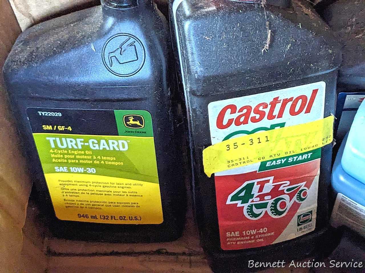 Several bottles of ATV oil, yard torch and fuel, and more.