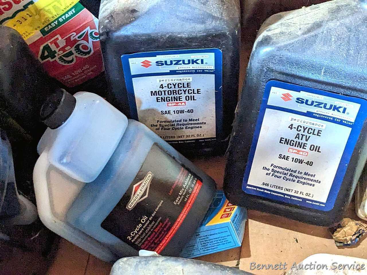 Several bottles of ATV oil, yard torch and fuel, and more.