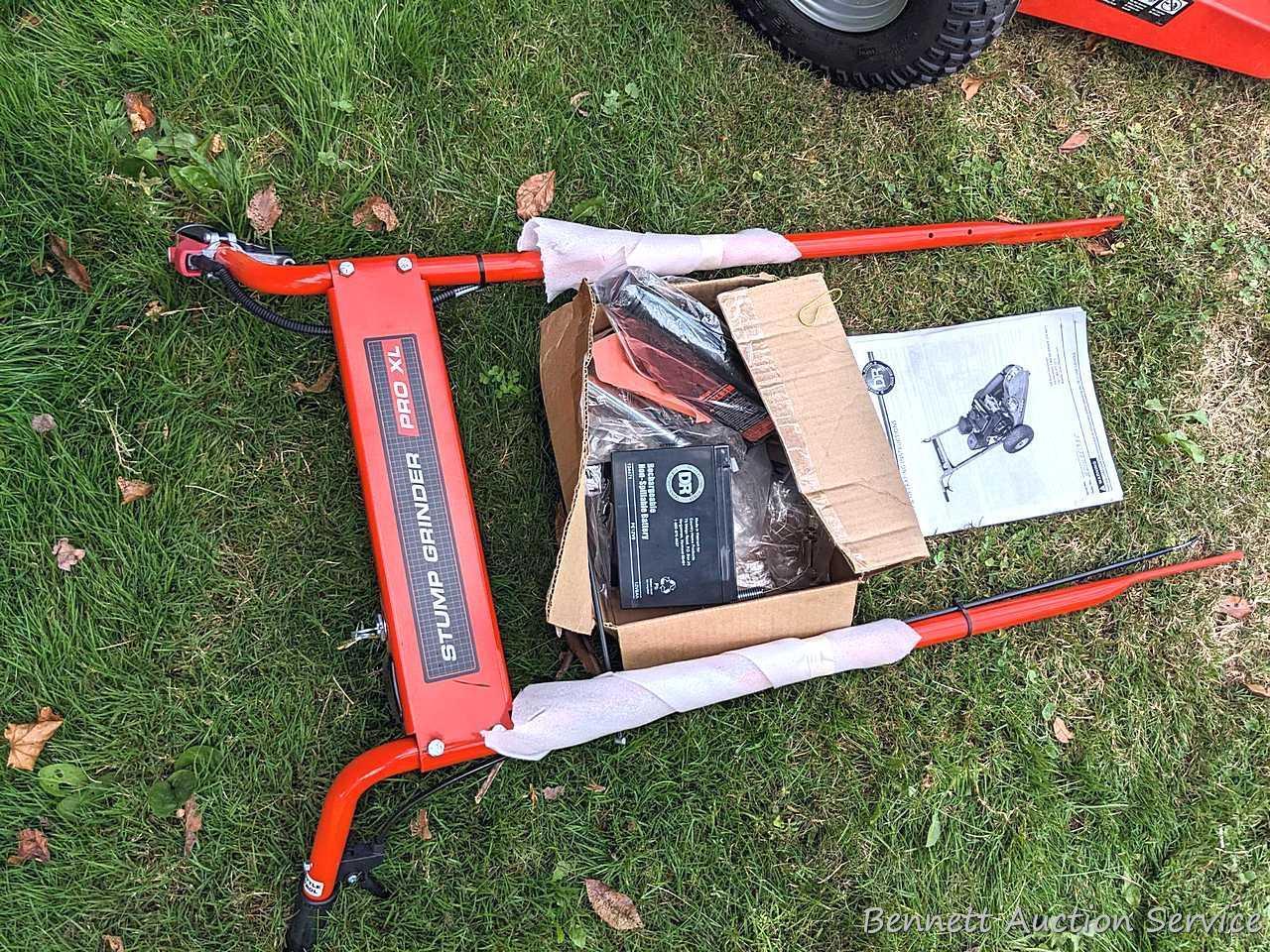 DR Stump Grinder Pro XL comes with manual, battery, oil, wrenches, etc. Appears as-new, as it's not