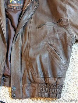 Brown leather jacket by Wilsons is men's size XL and in good condition.