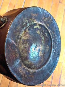 Copper colored tea kettle with black handle. Lid doesn't seat easily, measures 9-1/2" over handle.