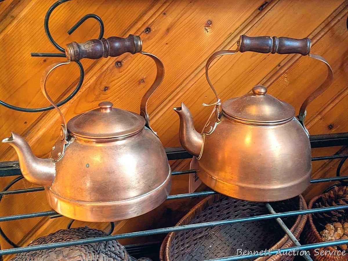 Pair of copper colored tea kettles with wooden handles. Measure 8" over handle and are in good