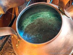 Pair of copper colored tea kettles with wooden handles. Measure 8" over handle and are in good