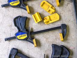 Four Quick-Grip bar clamps, largest measures 20" long.