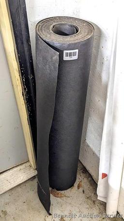 Roll of 36" tar paper and partial roll of house wrap.