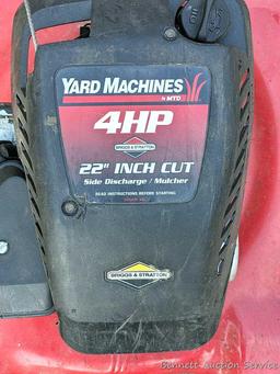 Yard Machines lawn mower with a 22" cut and a 4 HP Brigs and Stratton engine. The mower fired right