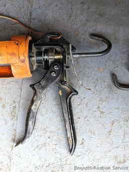 Pair of orange caulking guns. The larger gun is a heavy duty one and measures 17" over the handle.