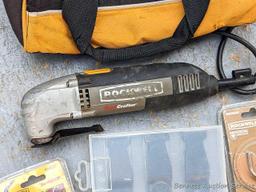 Rockwell SoniCrafter trim saw in bag and includes a variety of blades. Some blades appear to be