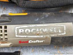 Rockwell SoniCrafter trim saw in bag and includes a variety of blades. Some blades appear to be