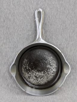 Griswold No. 4 cast iron skillet with nickel plating and large logo. Bottom marked Erie PA USA, 702.