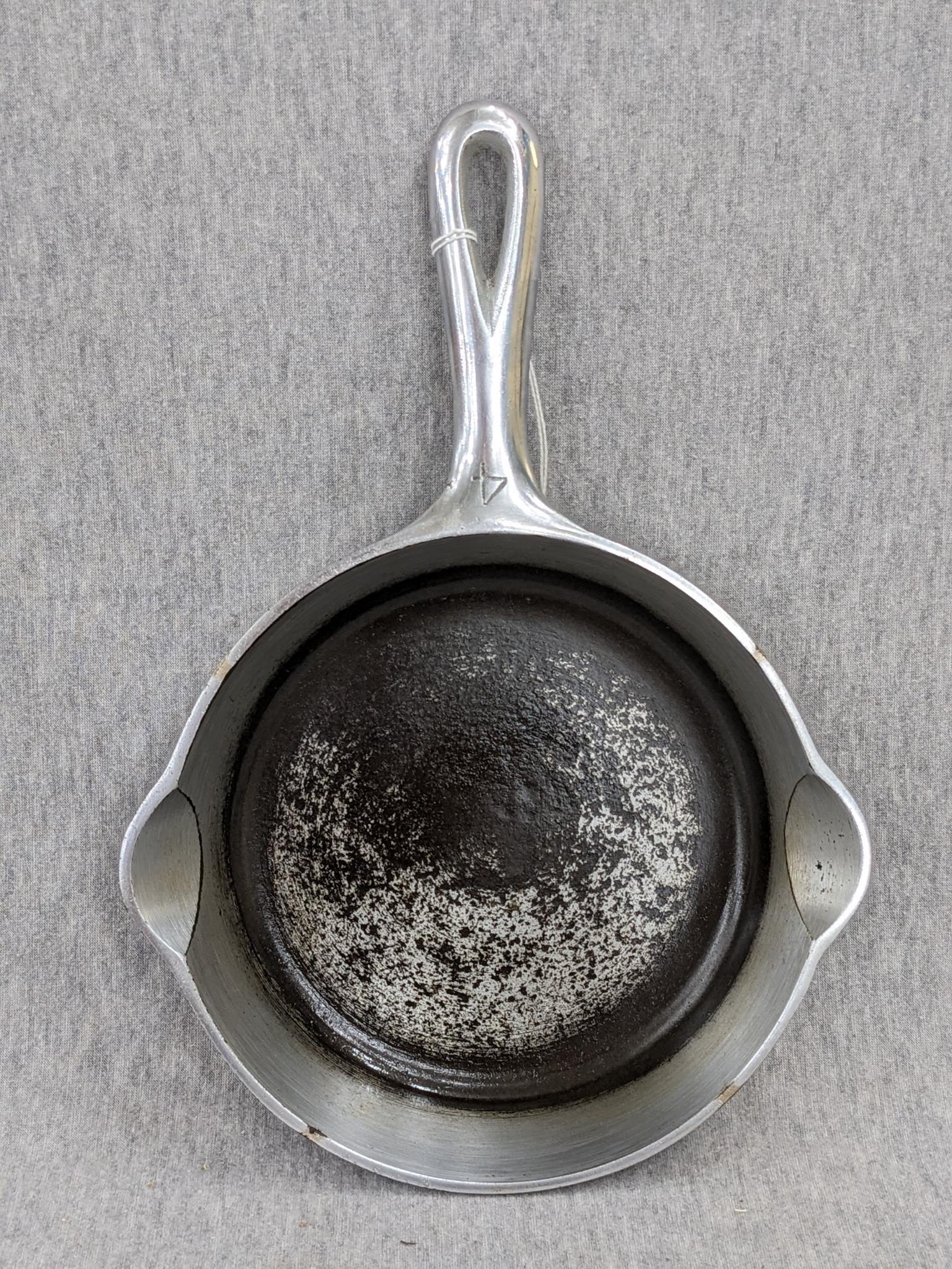 Griswold No. 4 cast iron skillet with nickel plating and large logo. Bottom marked Erie PA USA, 702.