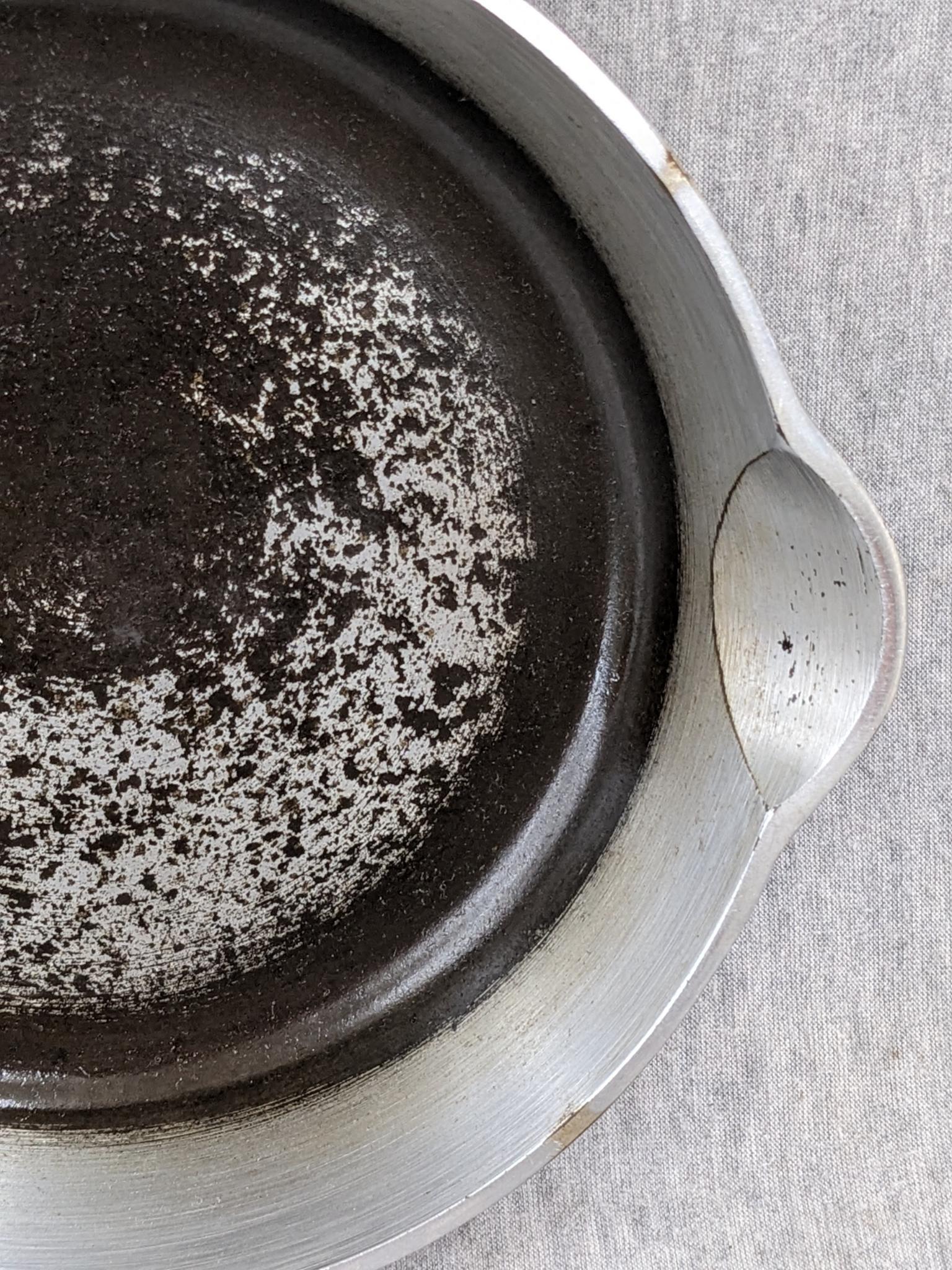 Griswold No. 4 cast iron skillet with nickel plating and large logo. Bottom marked Erie PA USA, 702.