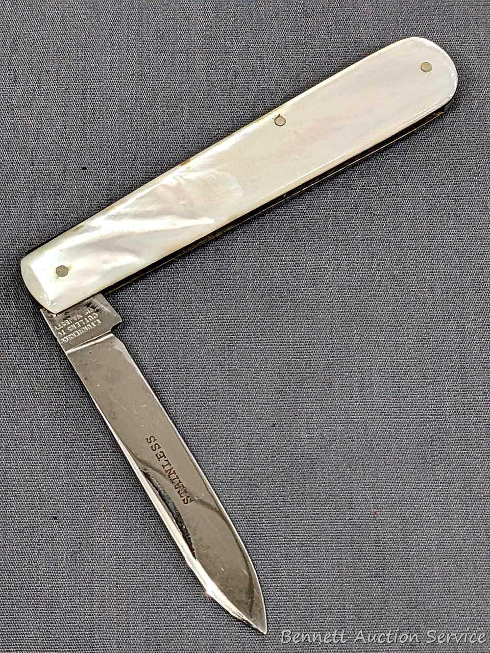 Antique fruit knife with a stainless steel blade, and mother of pearl handle slabs. The knife was