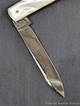 Antique fruit knife with a stainless steel blade, and mother of pearl handle slabs. The knife was