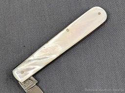 Antique fruit knife with a stainless steel blade, and mother of pearl handle slabs. The knife was