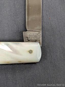 Antique fruit knife with a stainless steel blade, and mother of pearl handle slabs. The knife was