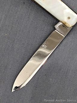 Antique fruit knife with a stainless steel blade, and mother of pearl handle slabs. The knife was