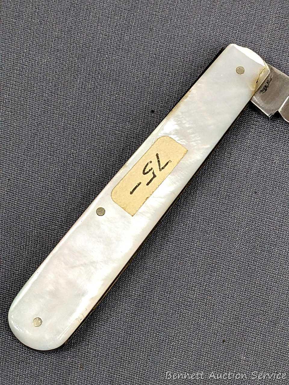 Antique fruit knife with a stainless steel blade, and mother of pearl handle slabs. The knife was