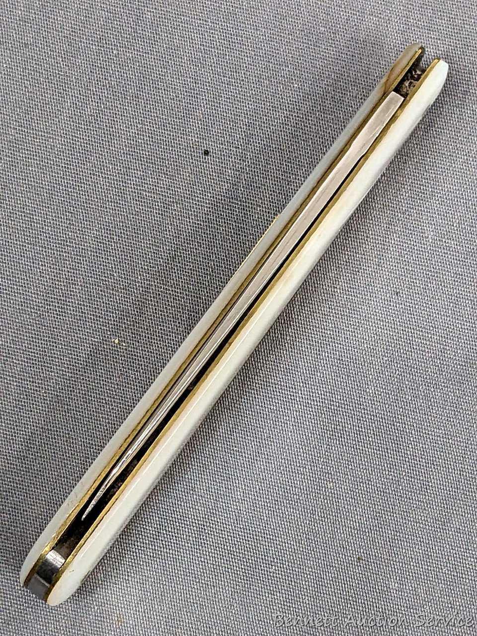 Antique fruit knife with a stainless steel blade, and mother of pearl handle slabs. The knife was