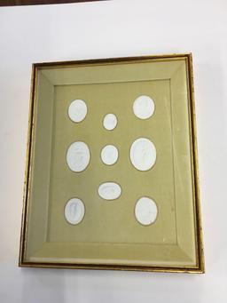 Molded plaster sculptures encased in shadow box