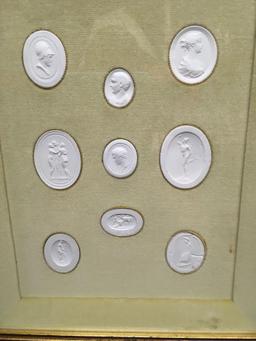 Molded plaster sculptures encased in shadow box