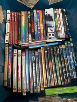Assorted DVDs and CDs. Over 80 pieces includes storage tub