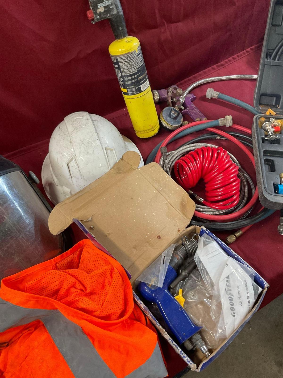 Assorted items. Gauge, hoses, air gun, helmet, etc