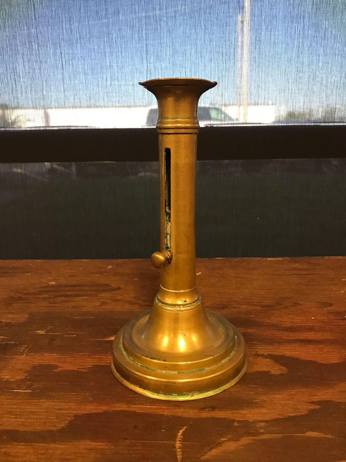Antique brass candlestick with lever