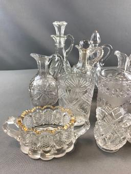 Group of clear pressed glass cruets and more