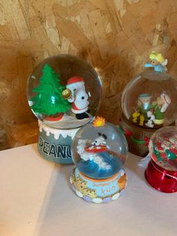 Group of five Peanuts snow globes