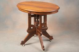 Antique Walnut Victorian oval Lamp Table with intricate carved base and original porcelain casters,