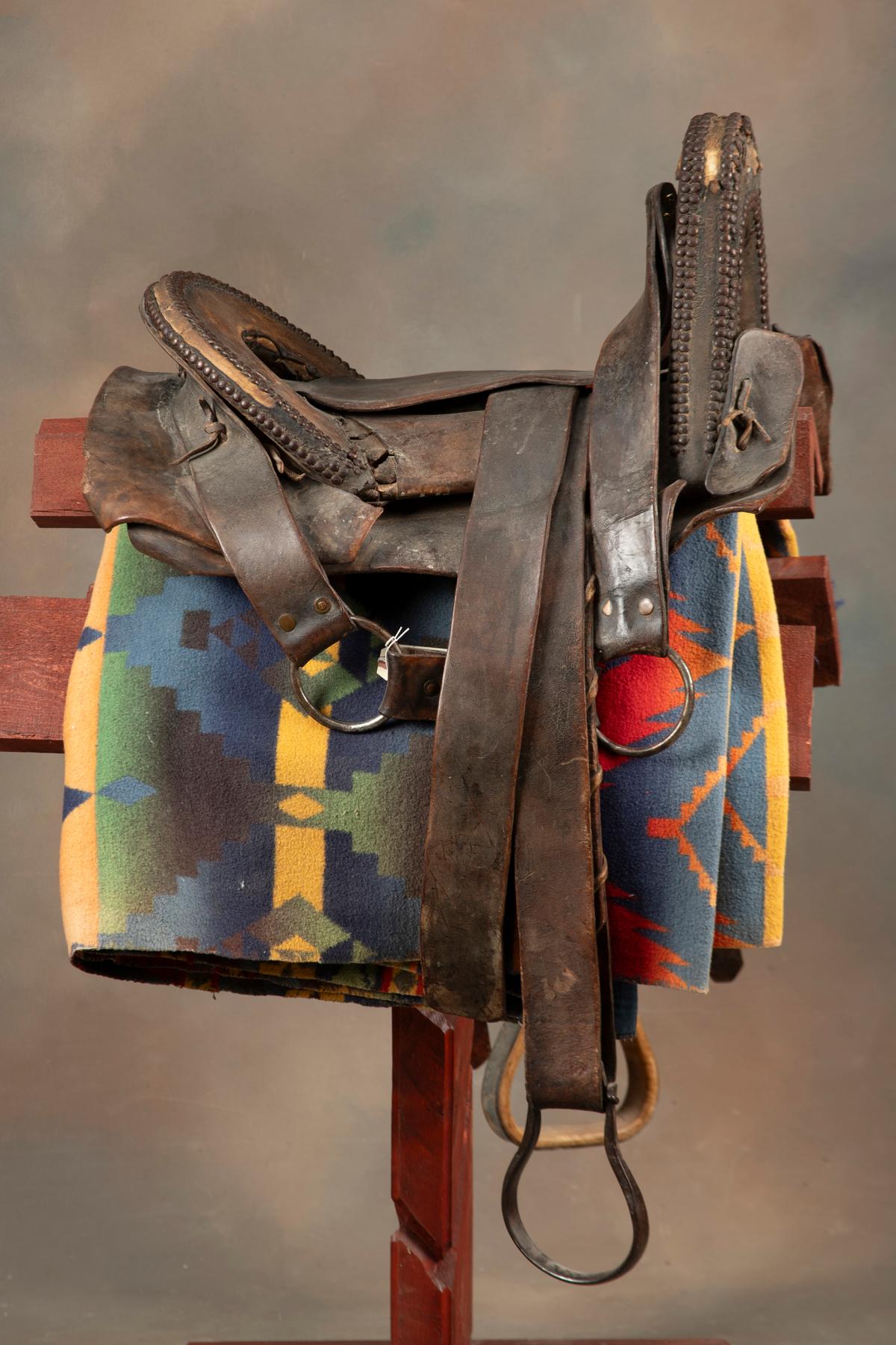 Fine early period leather Saddle, Indian used with unique horn and loop seat. Horn and seat are deco