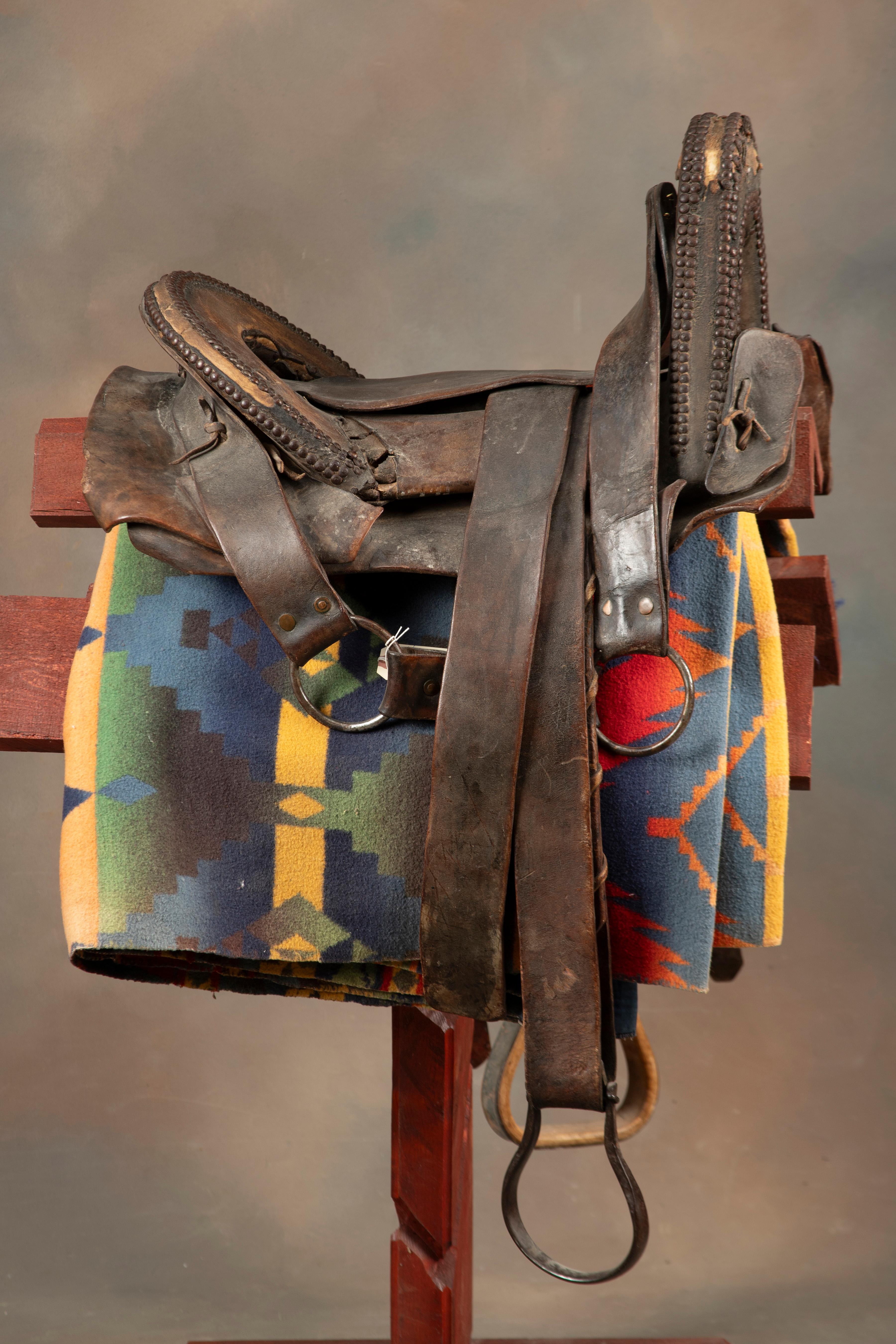 Fine early period leather Saddle, Indian used with unique horn and loop seat. Horn and seat are deco