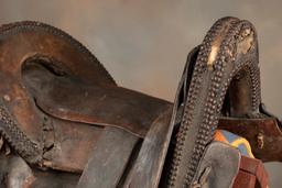 Fine early period leather Saddle, Indian used with unique horn and loop seat. Horn and seat are deco