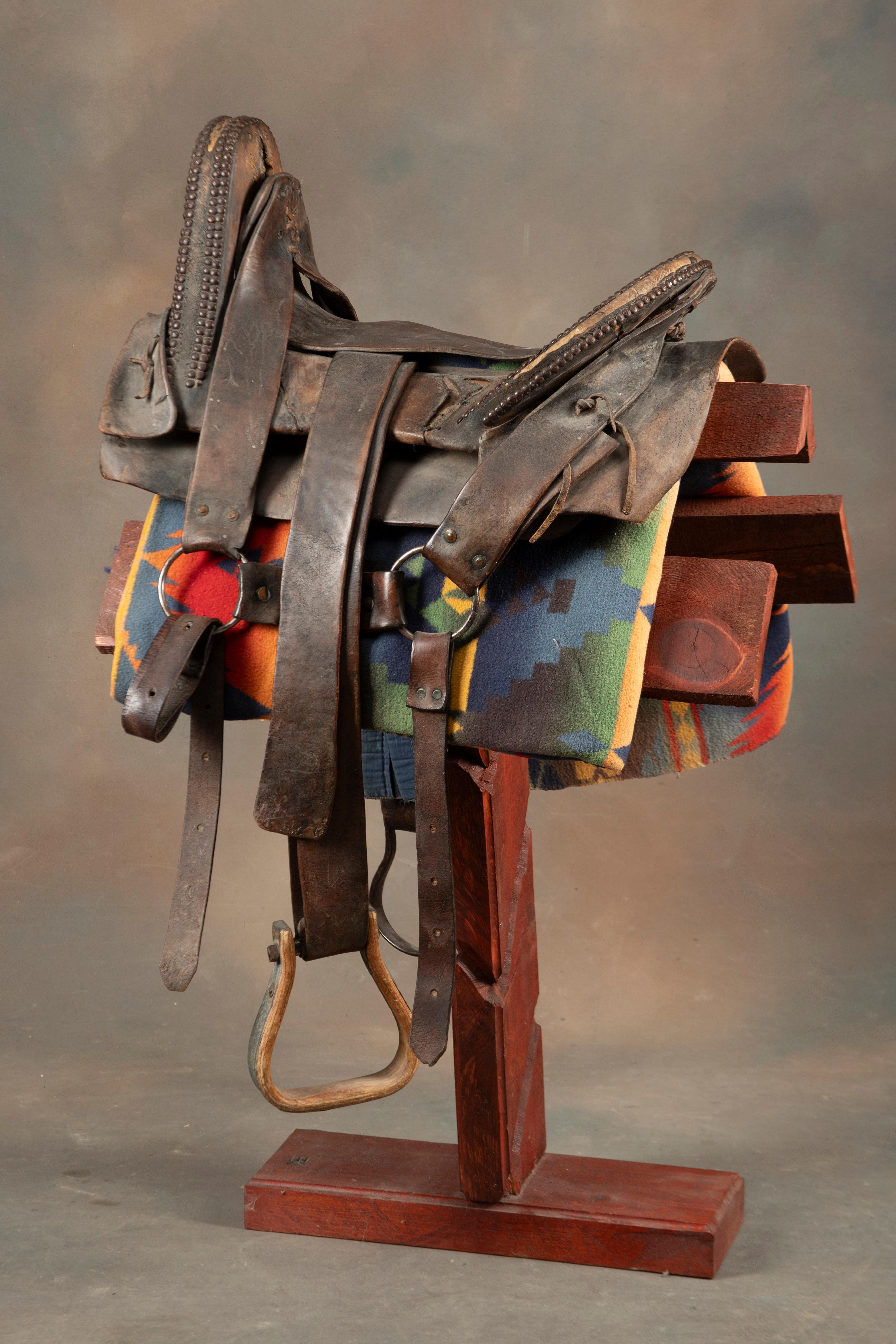 Fine early period leather Saddle, Indian used with unique horn and loop seat. Horn and seat are deco
