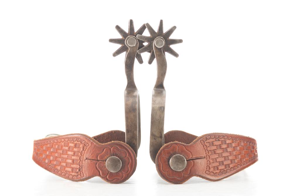 Pair of "Crockett" marked, single mounted Spurs with diamond shaped silver mountings on heel bands.