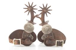Pair of single mounted Iron Spurs with engraved silver conchos on heel bands. Believed to be shop-ma