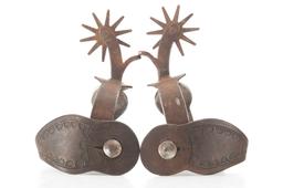 Pair of single mounted Iron Spurs with engraved silver conchos on heel bands. Believed to be shop-ma