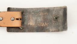 Turquoise and silver oblong Buckle, 6" L x 4 1/4" T, accompanied by a western tooled Belt with wagon