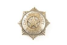 Sunburst shaped vintage Badge marked â€œOKLAHOMA CITY POLICEâ€� with â€œ100â€� in raised star center