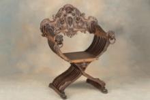 One of a near matching pair of heavily carved antique Fire Side Chairs, circa 1880s-90s, with massiv