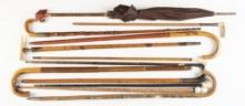 Collection of 12 Walking Sticks, Canes and two Umbrellas, one umbrella is concealed, in various shap