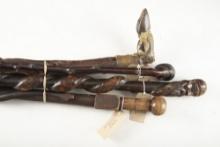 Group of four (4) vintage folk art wooden Canes. (1) A 37" L  Cane with carved bust of a man pommel