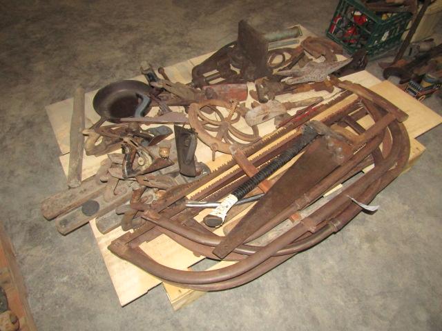 1648. PALLET OF BOW SAWS, HORSE SHOES, PLANES, WELL WHEEL, CAST IRON PAN AN