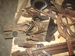 1648. PALLET OF BOW SAWS, HORSE SHOES, PLANES, WELL WHEEL, CAST IRON PAN AN