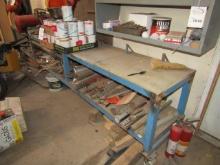 1509. METAL 20” X 12’ WORK BENCH ON ROLLERS WITH MISC. IRON ON SHELF