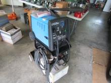 1827. CLARKE-WELD MIG 180 EN FAN COLLED WIRE FEED WELDER ON STAND, INCLUDES