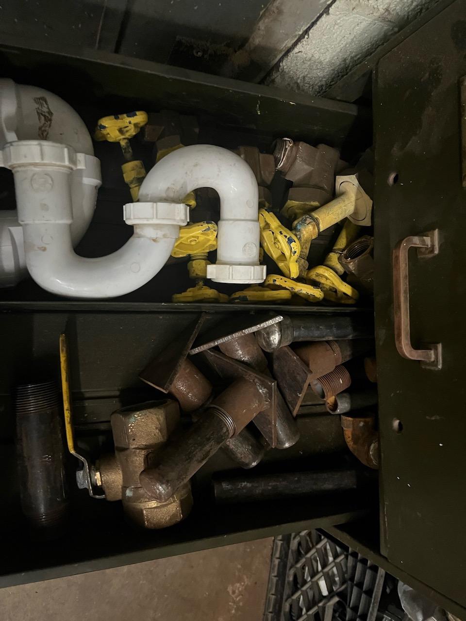 Loc: 3 Maint.  Cabinet with pipe fittings and window and door hardware